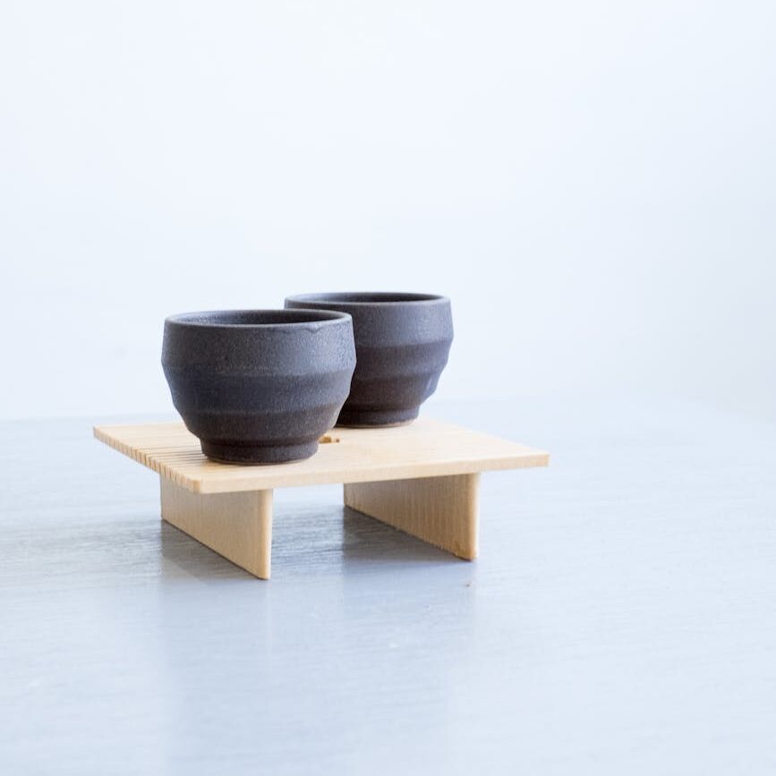 gray ceramic bowl on brown wooden rack